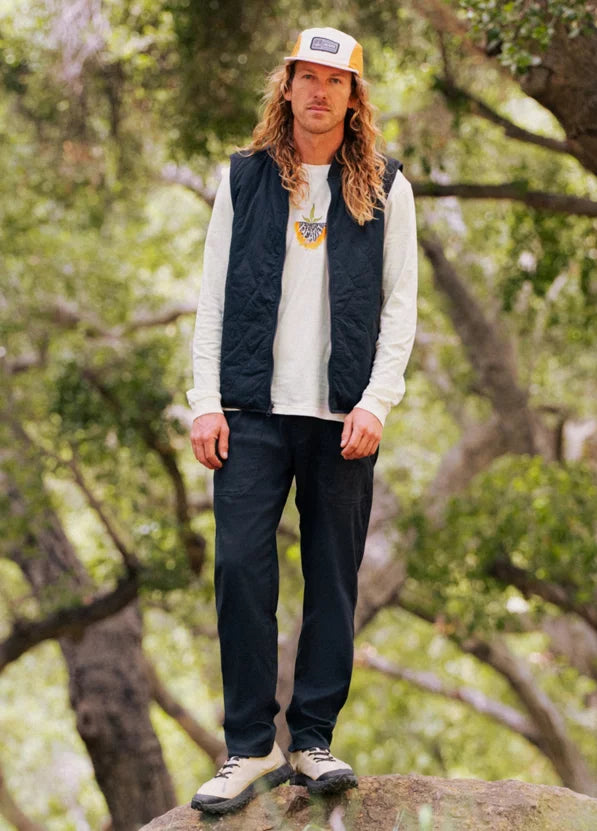 Man standing outdoors with trees in the background