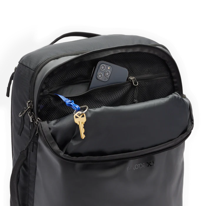 Cotopaxi Allpa 35L Travel Pack Black zipper pockets showing a phone and key