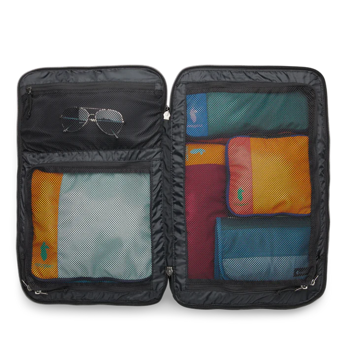 Cotopaxi Allpa 35L Travel Pack Black inside view with other bags inside and a pair of sunglasses