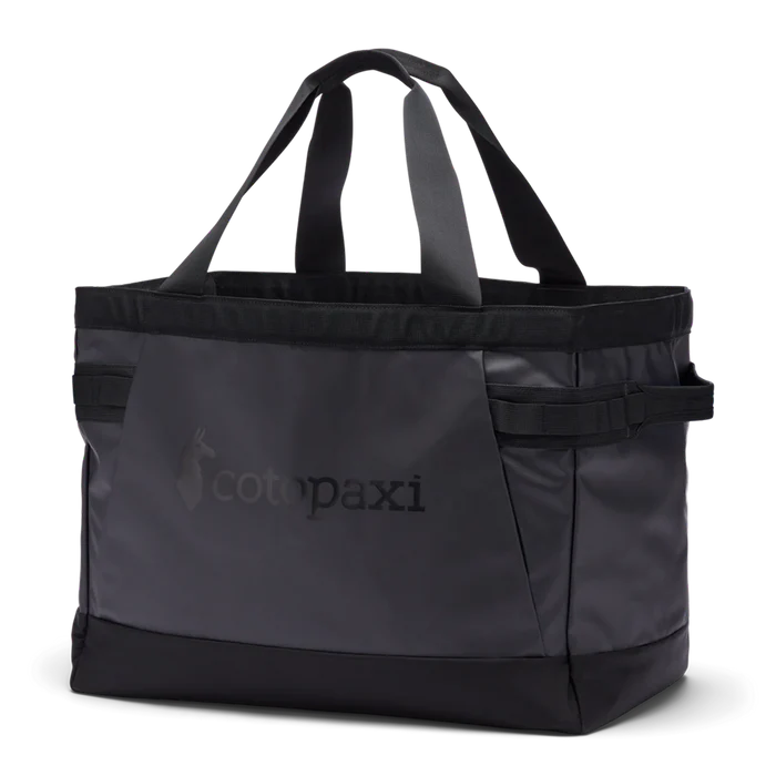 Black tote bag with 'cotopaxi' logo on a white background