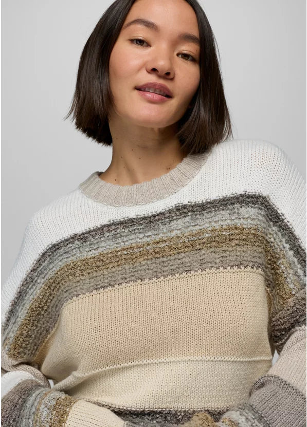Woman wearing a striped sweater against a plain background