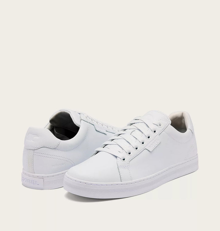 White sneakers on a light beige background
