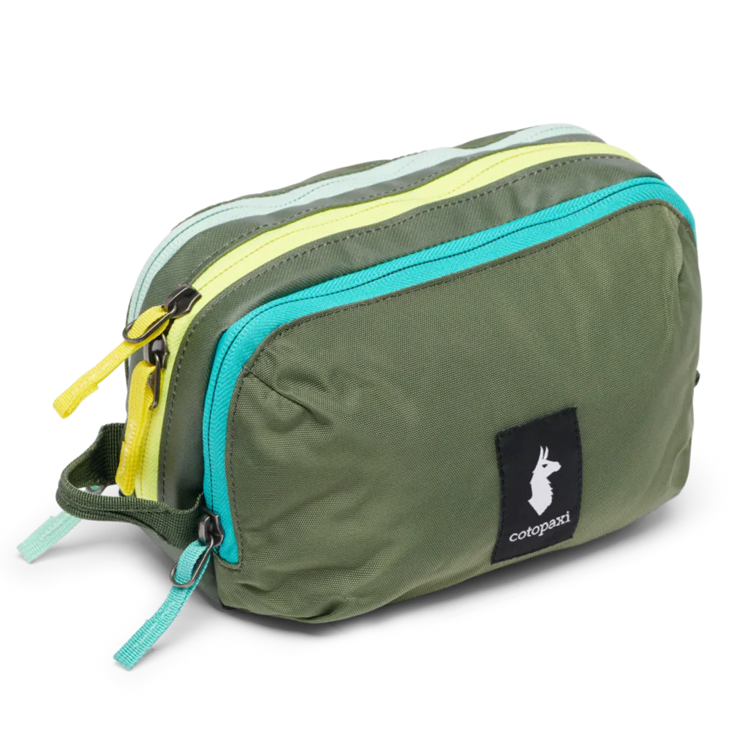 Green toiletry bag with colorful zippers on a white background Spruce