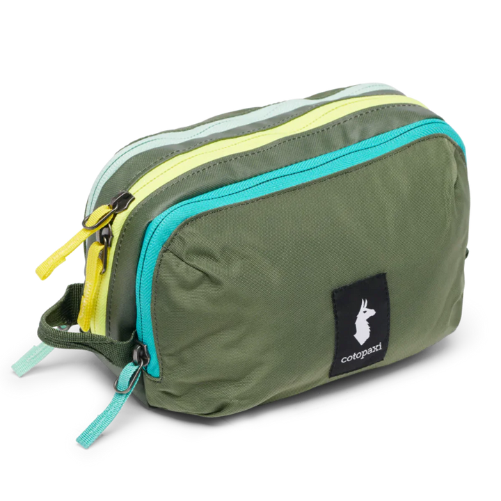 Green toiletry bag with colorful zippers on a white background Spruce