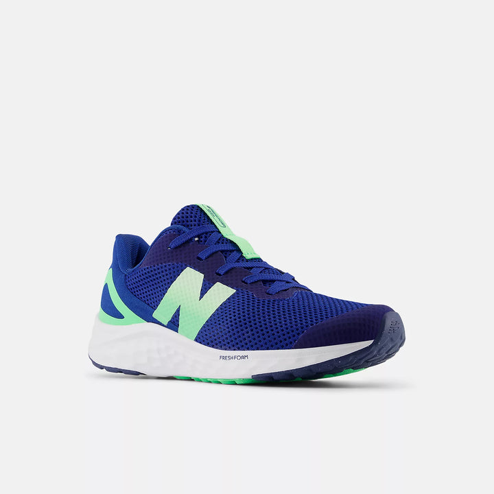 Blue running shoe with green accents on a white background